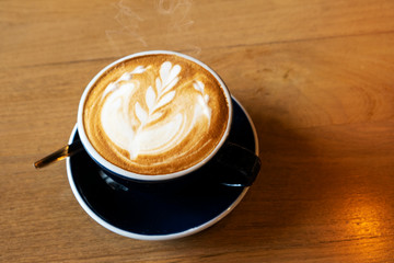 Hot latte on a wooden dining table