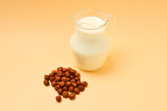 Hazelnut milk in a jar and nuts.