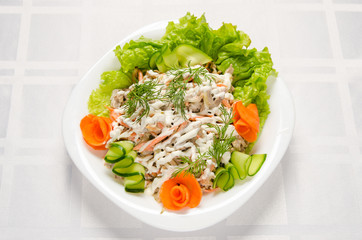 salad of boiled beef, champignons, carrots, pickled cucumbers, onions and lettuce seasoned with mayonnaise