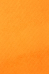 Macro photo of orange crumpled paper background