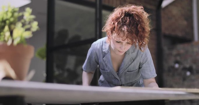 Young Adult woman doing carpentry DIY in garden