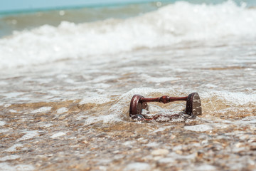 Hourglass on the beach, ocean. The concept of transience of time.
