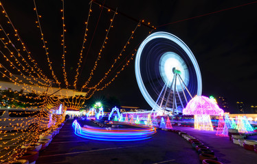 Blur rotate moving of Ferris wheel with lighting at carnival park in night time     