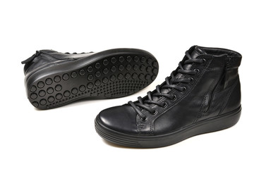 Men's black leather shoes and a black camera on a isolated on white background. Copy space.