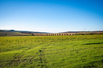 Historic railroad stone arch bridge near Spinazzola. Murgia, Apulia region, Italy