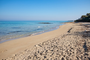 Sandy beach with transparent sea water. Apulia region, Italy