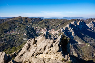 Fototapeta premium Landscape of Dolomites of Basilicata mountains called Dolomiti Lucane. In the background Castelmezzano village. Basilicata region, Italy