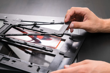 Professional technician hand scanning negative film and slides,
