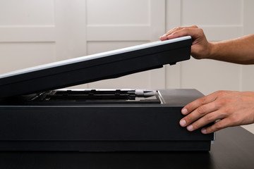Professional technician hand scanning negative film and slides,