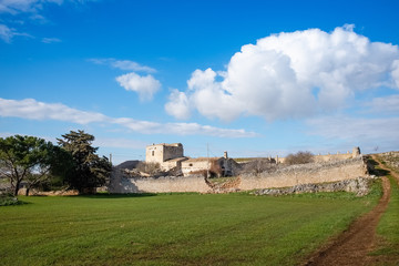 Typical Murgia landscape with an old stone manor farm called masseria. Apulia, Italy.