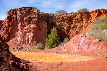 Abandoned open-pit bauxite mine with lake near Spinazzola - Apulia, Italy