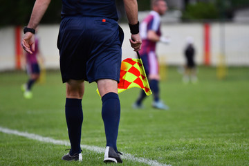 Assistant referee or Lineman of football or soccer holding flag