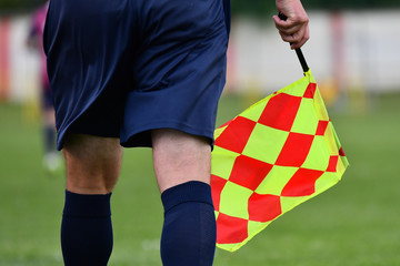 Assistant referee or Lineman of football or soccer holding flag