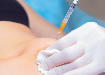 Beautician makes the patient anti-cellulite injection. Close-up. Body care concept.
