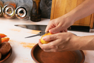 Cook cleans onions with a knife close-up. Organic cooking concept.