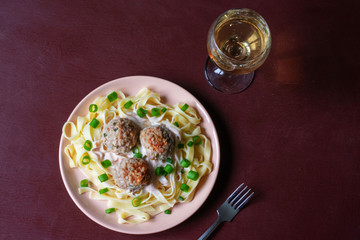 Pasta with meatballs on a dark background