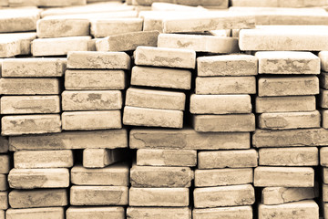 Lots of old paving tiles. Dismantled garden path. Selection focus. Shallow depth of field. Toned