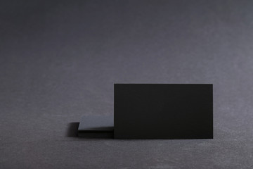 Photo of black blank business cards on a black background. Templ