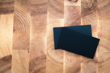 Photo of black blank business cards on wooden background. Templa