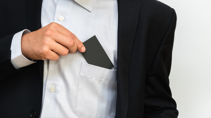 Young man takes out blank business card from the pocket of his s