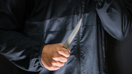 Street robber with a knife - killer person with sharp knife abou