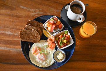 Big breakfast with eggs, fruit and bread