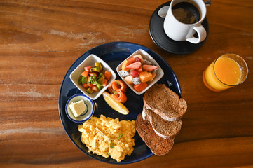 Big breakfast with eggs, fruit and bread