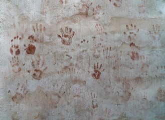 Bloody red color hands on concrete wall texture