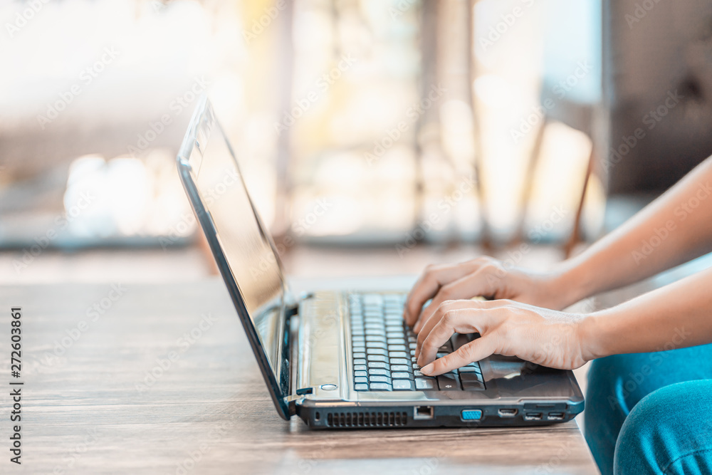 Poster man's hands using laptop in home.
