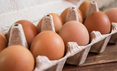 Chicken eggs on wooden background