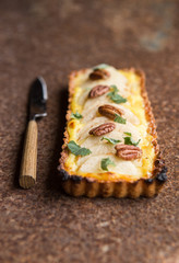  Pear tart with  pecan nuts  and custard cream, top view, flat lay , vertical composition