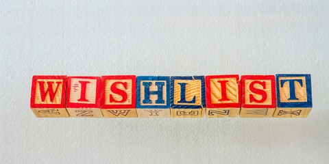 The term wishlist visually displayed using colorful wooden blocks on a clear background image with...