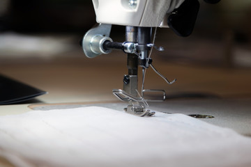 Close up of modern sewing machine and item of clothing, old sewi