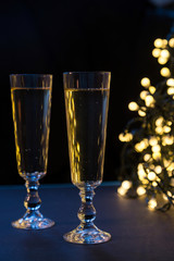 Two champagne glasses on Christmas. Defocused lights bokeh backg