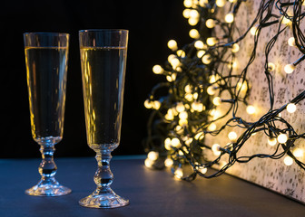 Two champagne glasses on Christmas. Defocused lights bokeh backg