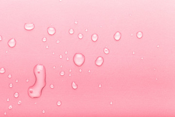 Drops of water on a color background. Pink. Toned