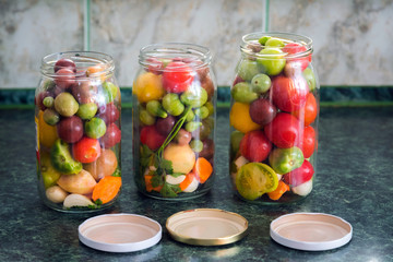 Jars of pickled vegetables. Traditional marinated food - tomatoe