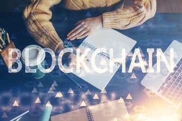 Cryptocurrency hologram over hands taking notes background. Concept of blockchain. Multi exposure