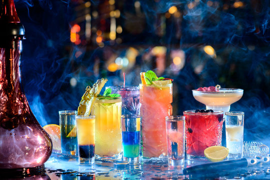 Set of alcoholic cocktails in a hookah with beautiful smoke and space for text.
