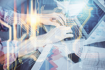 Double exposure of world map hologram with man working on computer on background. Concept of worldwideweb.