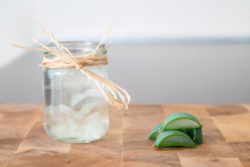 Essence from aloe vera plant in cosmetic bottle with slices of p