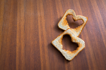 Toasted White Bread Toasts With Heart Shape On Brown Wooden Back
