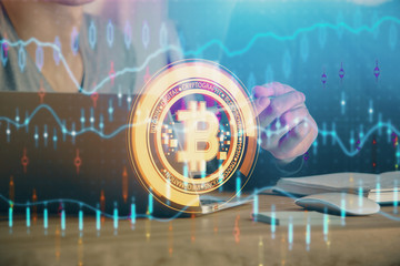 Fototapeta premium Crypto currency theme hologram with businessman working on computer on background. Concept of blockchain. Double exposure.
