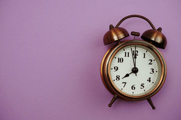 vintage alarm clock with space copy on Purple background