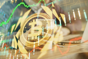 Crypto currency theme hologram with businessman working on computer on background. Concept of blockchain. Double exposure.