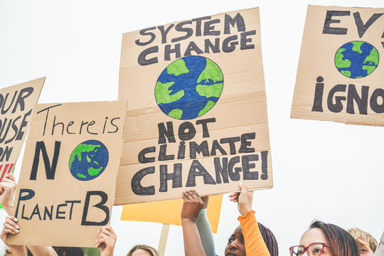 Group of demonstrators on road, young people from different culture and race fight for climate change - Global warming and enviroment concept - Focus on banners