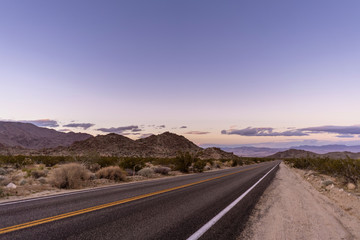 Desert road at sunset in Joshua Tree National Park, California.
