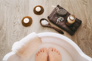 Fototapeta na wymiar Taking magnesium foot bath for better absorbent of vitamin mineral magnesium chloride. Soaking feet in relaxing bath. Relieves muscle tension, aid to skin and bone health, suitable during pregnancy.