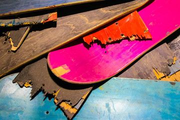 Broken colorful skateboard decks stacked on top of each other, s