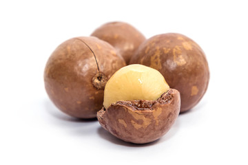 Macadamia oil and nuts on white background